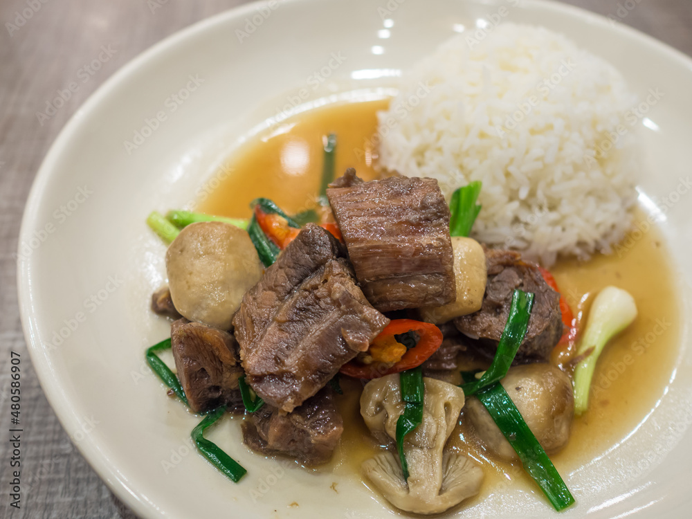 stir beef steam cook with vegetable and rice on a white dish stir beef steam cook with vegetable and rice on a white dish