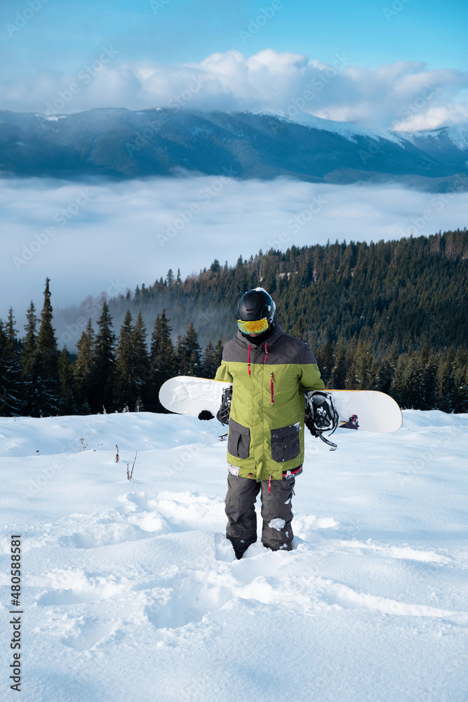 man snowboarder portrait carpathian mountains on background