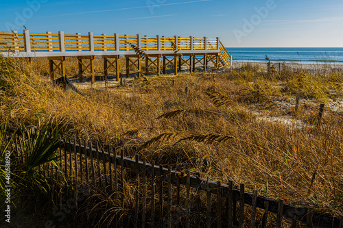 Fototapeta Naklejka Na Ścianę i Meble -  Dune Fence And Wooden Bridge to Surfside Beach, Myrtle Beach, South Carolina, USA