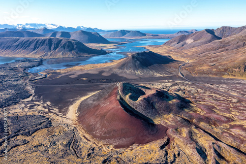 Extinct volcano, lava fields, lakes and mountains, with the sea in the distance. Drone shot of the Berserkjahraun region, Snaefellsnes Peninsula, Iceland. photo