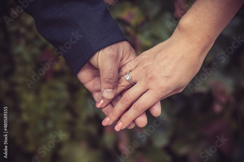 Close-up of hands, husband and wife, showing the wedding ring