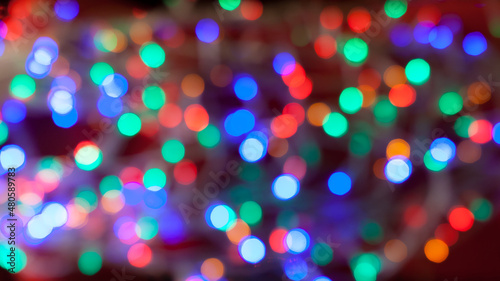 Multicolored abstract holidays lights in bokeh, on a dark background