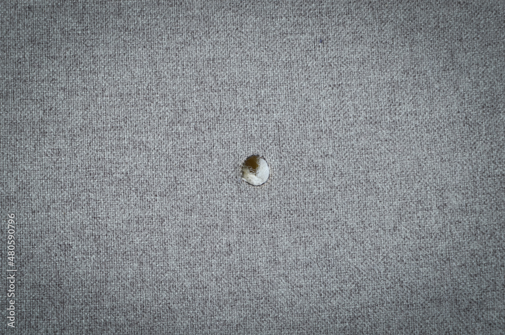Cotton fabric with a hole from a cigarette Cotton fabric with a hole from a cigarette