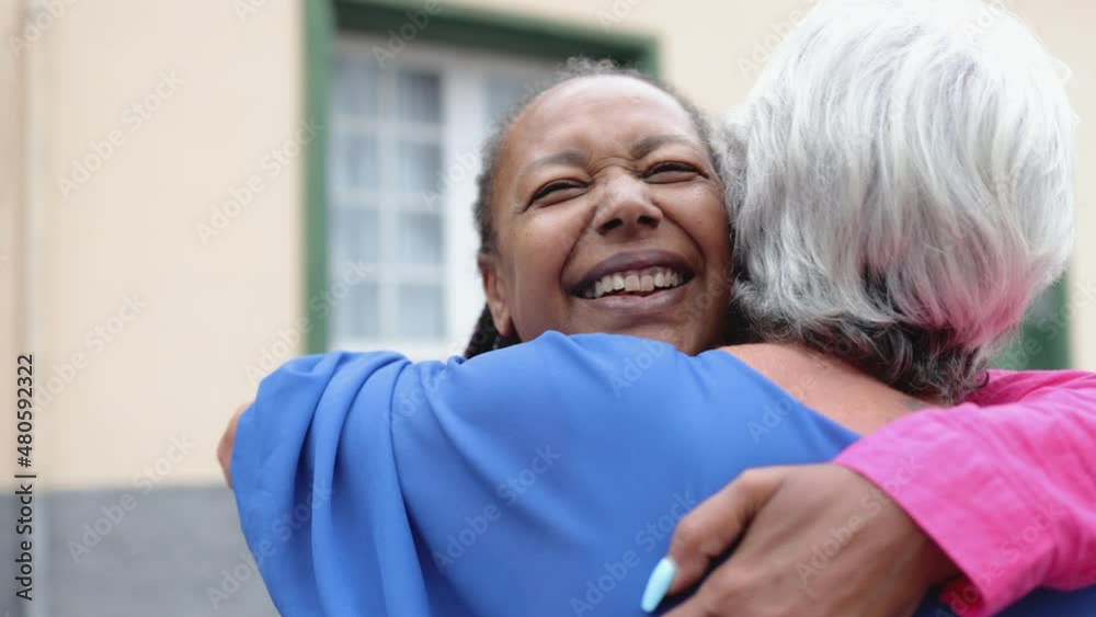 Multiracial senior women hugging each other - Elderly friendship and love concept