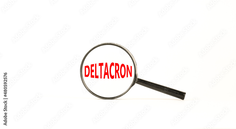 Covid-19 corona deltacron symbol. The concept word Deltacron. Magnifying glass. Beautiful white table, white background. Medical, covid-19 corona deltacron variant concept. Copy space. Covid-19 corona deltacron symbol. The concept word Deltacron. Magnifying glass. Beautiful white table, white background. Medical, covid-19 corona deltacron variant concept. Copy space.