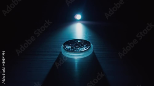 A bitcoin on a dark background is illuminated with a contrasting light . Cryptocurrency alternative currency. Cryptocurrency analysis. Creation of bitcoin. Bitcoin cryptocurr photo