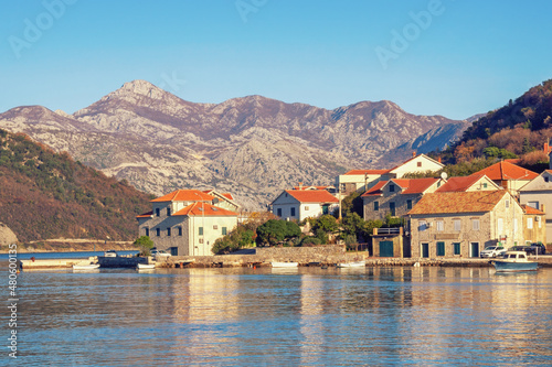 Calm sunny winter day. Beautiful Mediterranean landscape. Montenegro, Adriatic Sea, coast of Kotor Bay. Small seaside Lepetane village at foot of mountains © Olga Iljinich