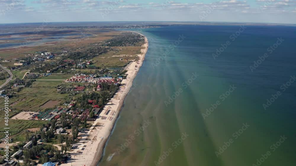 Beautiful flight in summer over the beach. People are resting near the sea. Houses for tourists. Beach umbrellas, rides, people swimming in the sea. Beautiful flight in summer over the beach. People are resting near the sea. Houses for tourists. Beach umbrellas, rides, people swimming in the sea.
