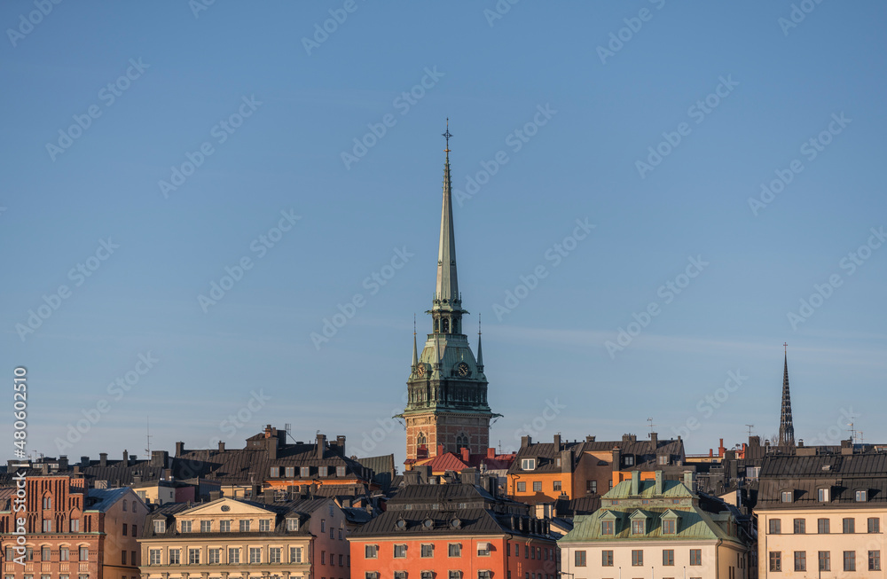 Panorama view of roofs of the old town Gamla Stan with spire of the German church and the Riddarholmskyrkan a sunny and snowy winter day in Stockholm