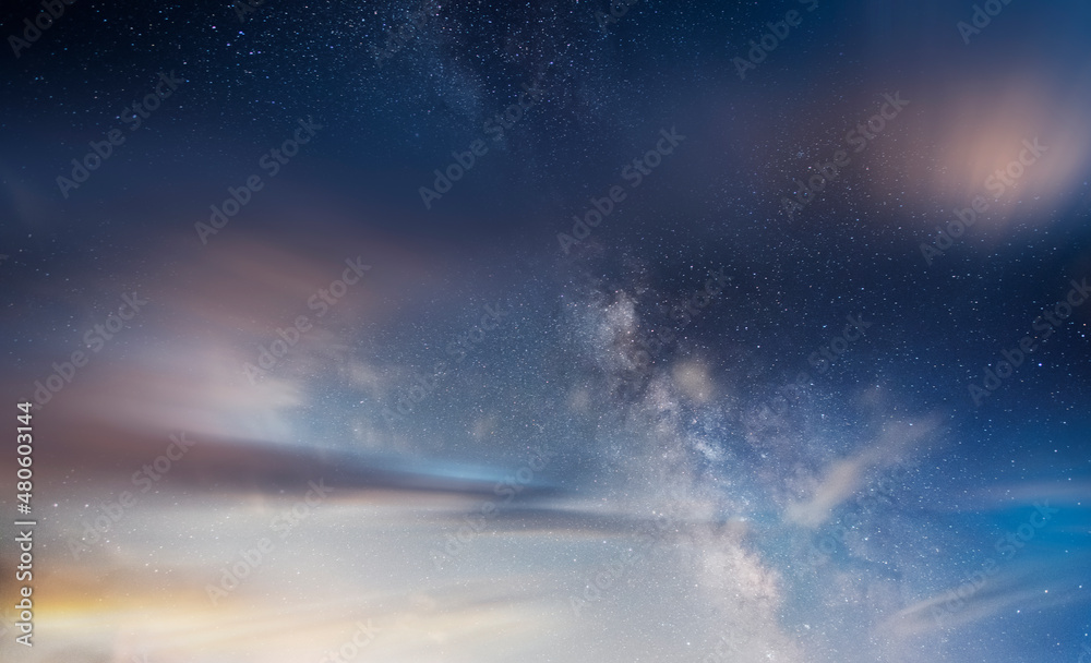 Beautiful long exposure dramatic clouds with milky way galaxy. Night starry sky  background.