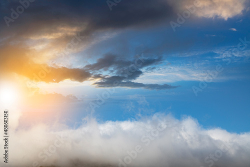 Fototapeta Naklejka Na Ścianę i Meble -  Fantastic fluffy clouds in the sunset sky. 
Sky background.