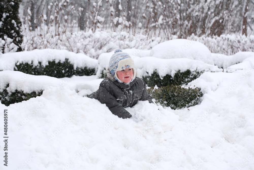 Little boy playing in a snowy park Little boy playing in a snowy park