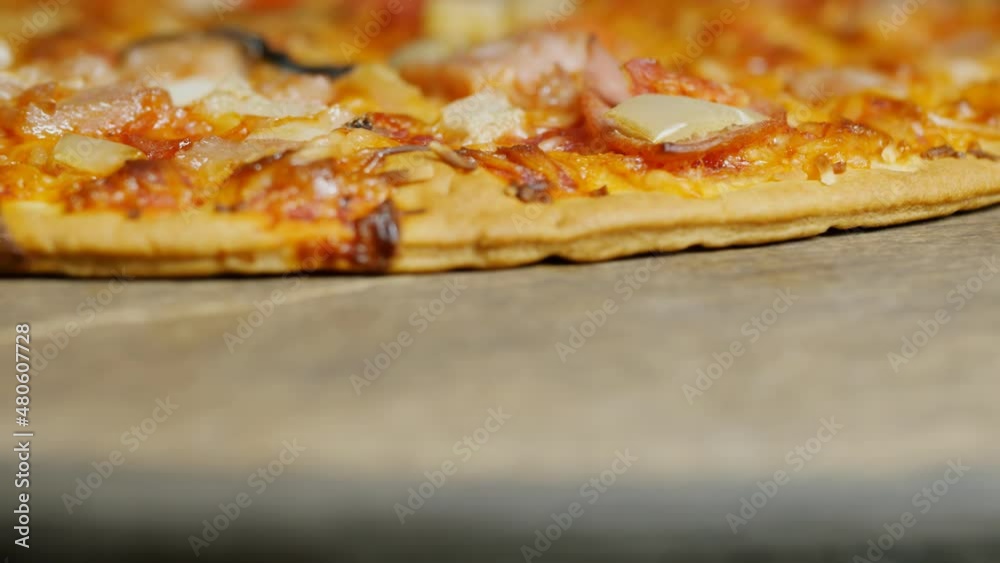 fresh hot pizza falls on a wooden brown table. Copy space below. Close-up. Italian pizzeria fresh hot pizza falls on a wooden brown table. Copy space below. Close-up. Italian pizzeria