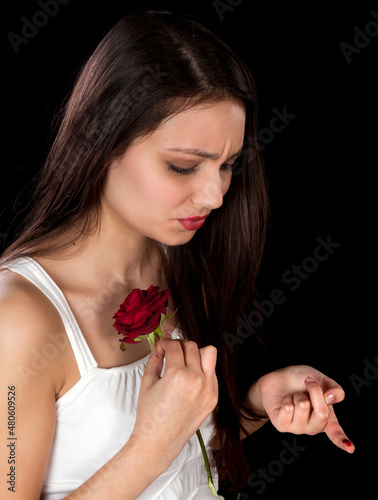 Rose pricking a finger