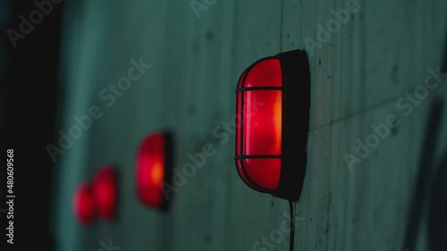 Many warning alert blinking lamps and danger attention sign on the concrete wall . Signalization , alarm , safety , security concept . Close up Shot on ARRI ALEXA Cinema Camera in Slow Motion .