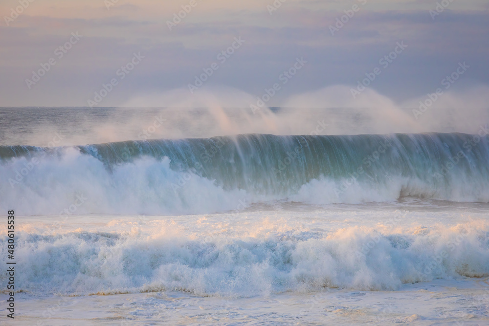 Ocean waves close up at sunset. Guincho beach, Cascais, Portugal