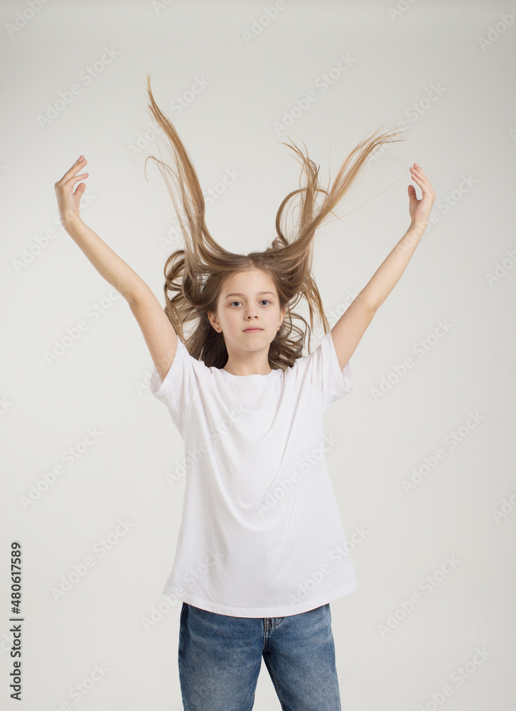 portrait of a young beautiful girl tossing her hair up on a white background portrait of a young beautiful girl tossing her hair up on a white background