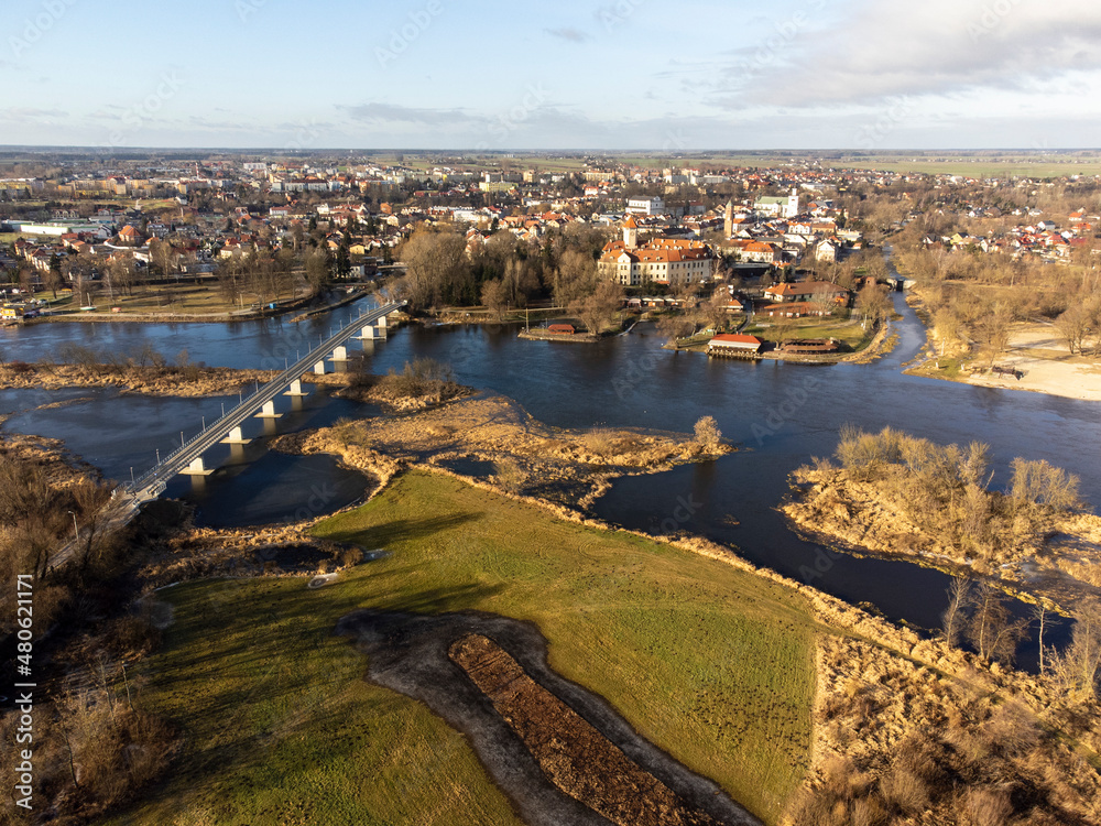A small town by the river and tourist attractions photographed from a drone flight on a sunny autumn day.