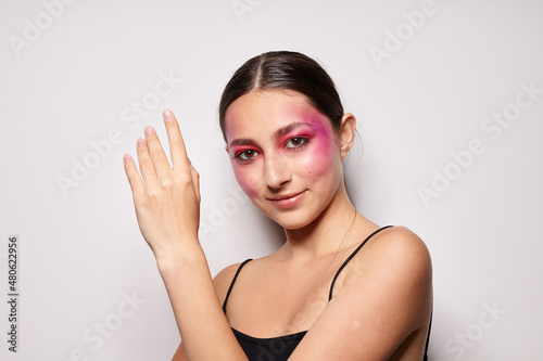 fashionable woman pink face makeup posing attractive look light background unaltered