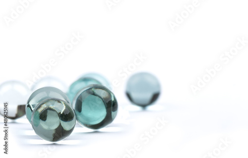 Glass balls with focus on the front and blurry back on a white background.