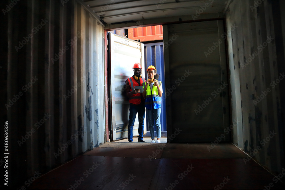  African American  black engineer they are working in container box yard area of  logistics transportation import export or shipping industry