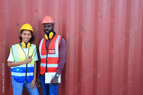 African American black engineer they are working in container box yard area of logistics transportation import export or shipping industry