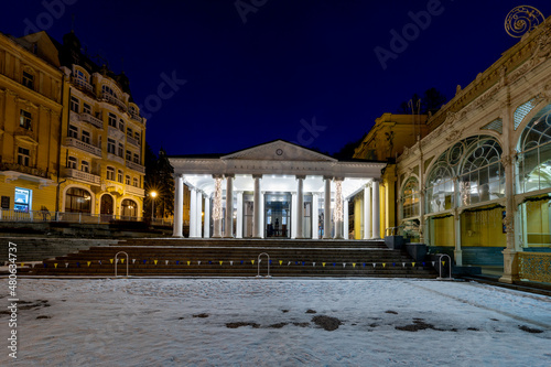 Mariánské Lázně (Marienbad) - white columns pavilion of mineral water spring in winter - evening on the spa colonnade