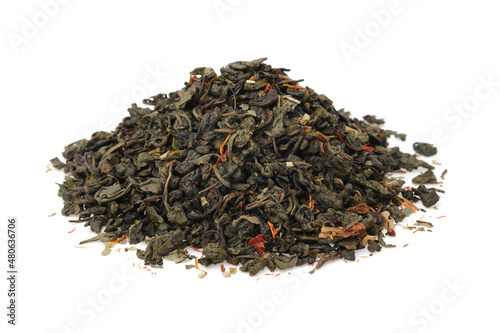 Pile of dry green gunpowder tea. Heap of green tea leaves with safflower flower petals.
