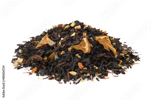 Pile of dry black tea leaves on white. Heap of aromatic black tea leaves with dried citrus slices and peel.