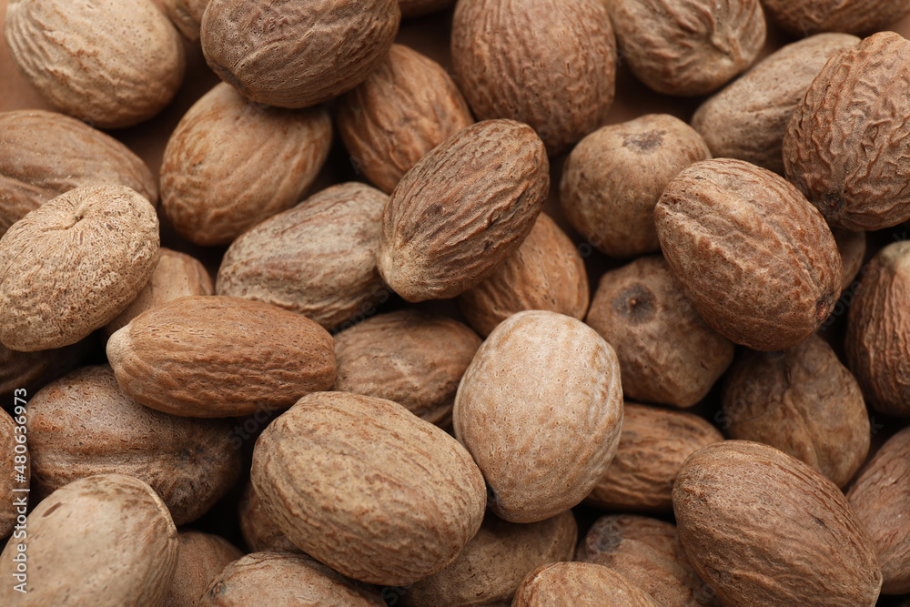 Heap of nutmeg seeds as background, top view Heap of nutmeg seeds as background, top view