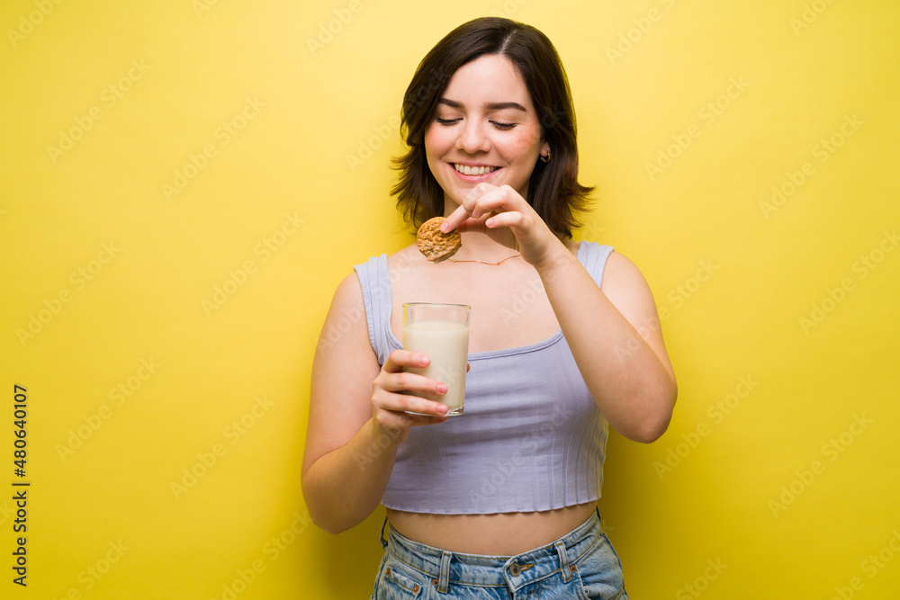 Cheerful woman eating comfort food Cheerful woman eating comfort food
