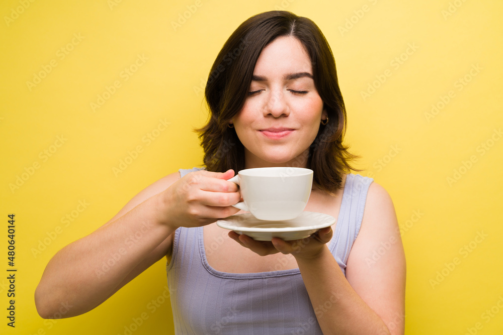Smiling woman enjoying her coffee Smiling woman enjoying her coffee