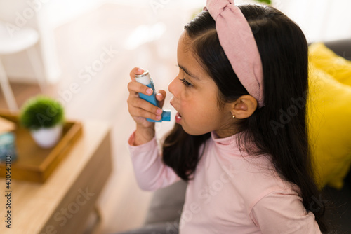 Adorable child having an asthma attack photo