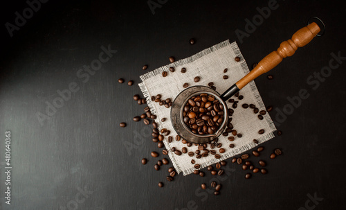 coffee concept. Coffee beans in Cezve, hot and fresh morning coffee. Brown roasted coffee. copyspace.Flat lay. Top view photo
