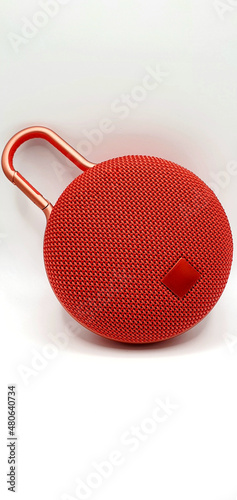 Red music speaker isolated closeup. Red speaker on a white background.