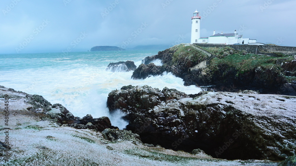 big waves hitting Fanad Head Lighthouse. coast of County Donegal in Ireland. wild atlantic way