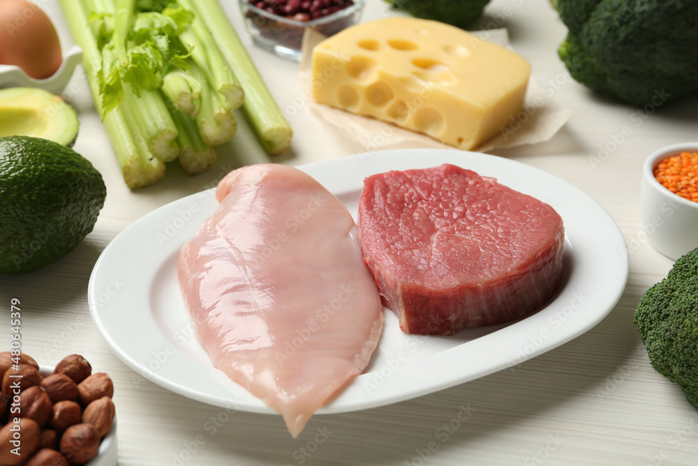 Fresh meat and other products on white wooden table. Sources of essential amino acids Fresh meat and other products on white wooden table. Sources of essential amino acids