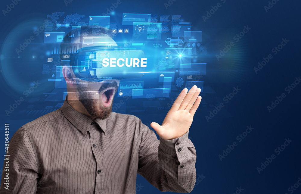 Businessman looking through Virtual Reality glasses Businessman looking through Virtual Reality glasses