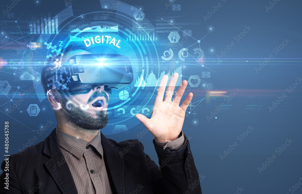 Businessman looking through VR glasses
