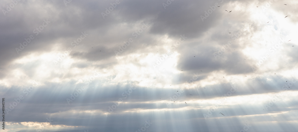 Fototapeta premium Dramatic sunbeams breaking through the clouds
