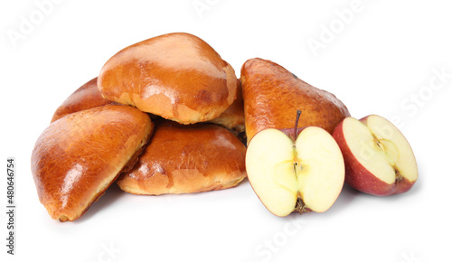 Delicious baked apple pirozhki and fruits on white background