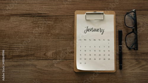 January calendar on a wooden table.