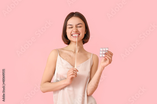 Young woman in pajamas and ...