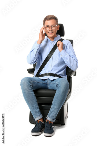 Man in car seat on white ba...