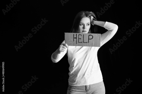 Sad woman holding paper wit...