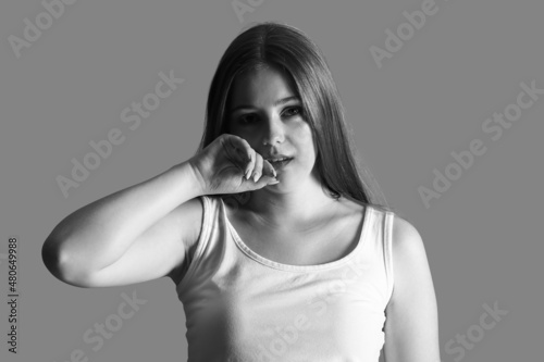 Sad woman on grey backgroun...