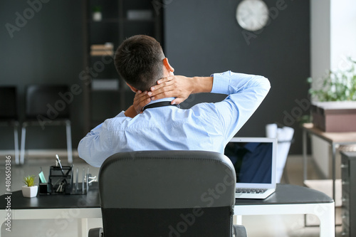 Businessman feeling neck pa...