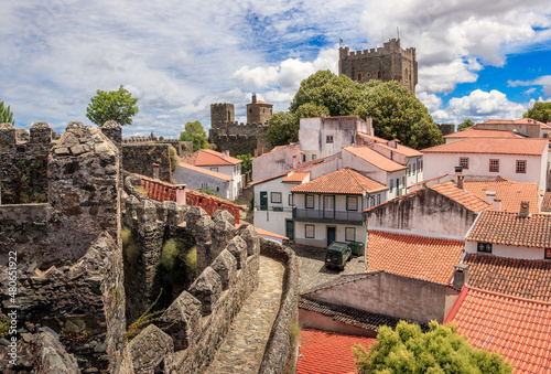Exterior walls and houses of the citadel of Bragança in Portugal, with the castle keep in the background.