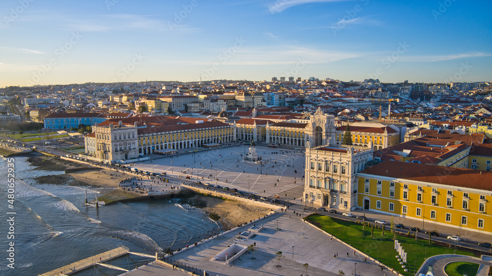 Aerial drone view of the Augusta Street Arch from Commerce Square in Lisbon, Portugal. Christmas tree in the plaza. Winter sunset.