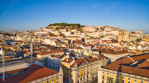 Lisbon, Portugal - January 13, 2022: Aerial drone view of Commerce Square in Lisbon, Portugal. Sao Jorge Castle in the background. Winter sunset. © Miguel
